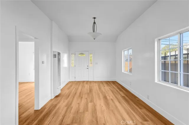 a view of a room with wooden floor closet and windows