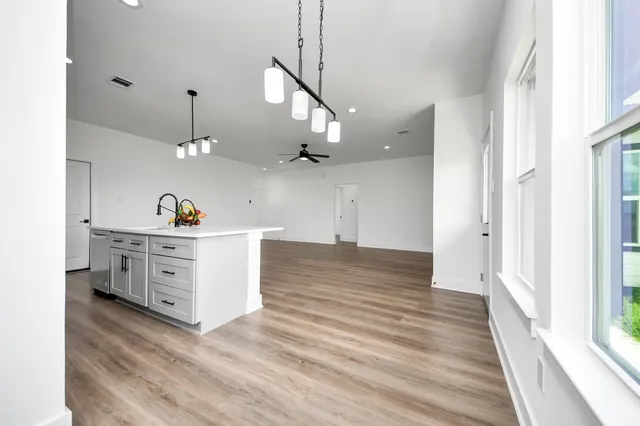 a view of a kitchen with cabinets and wooden floor