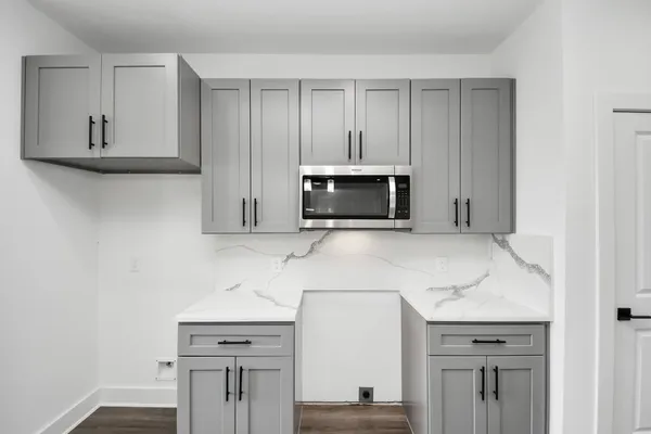 a kitchen with stainless steel appliances granite countertop a sink and a microwave