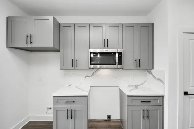 a kitchen with stainless steel appliances granite countertop a sink and a microwave