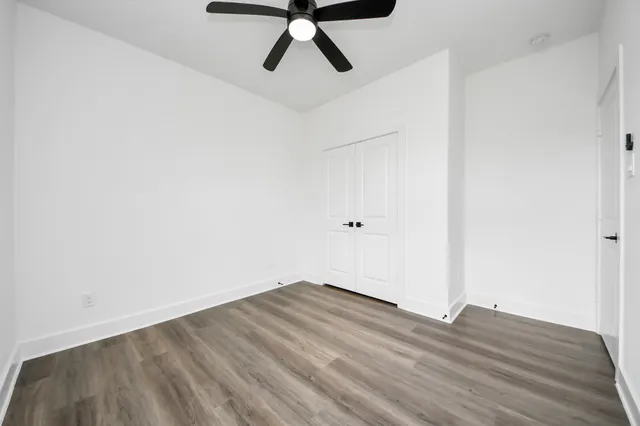 a view of a room with wooden floor