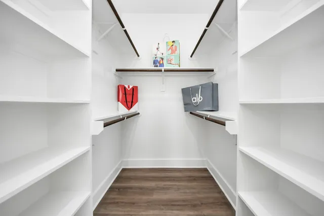 a view of hallway with stairs and wooden floor