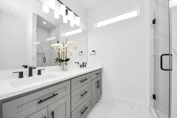 a bathroom with a double vanity sink mirror and next