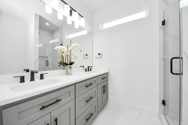 a bathroom with a double vanity sink mirror and next