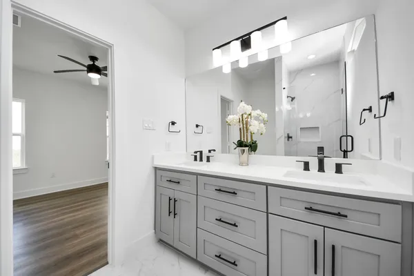 a bathroom with a double vanity sink mirror and double