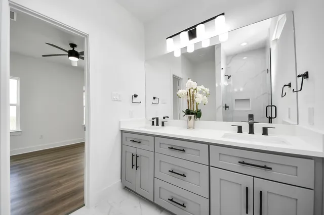 a bathroom with a double vanity sink mirror and double
