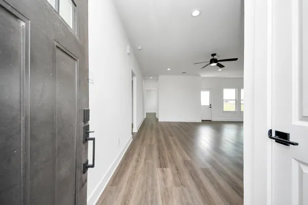 a view of a room with wooden floor and staircase