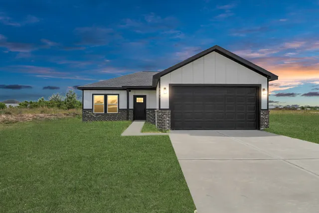 a front view of house with yard and green space