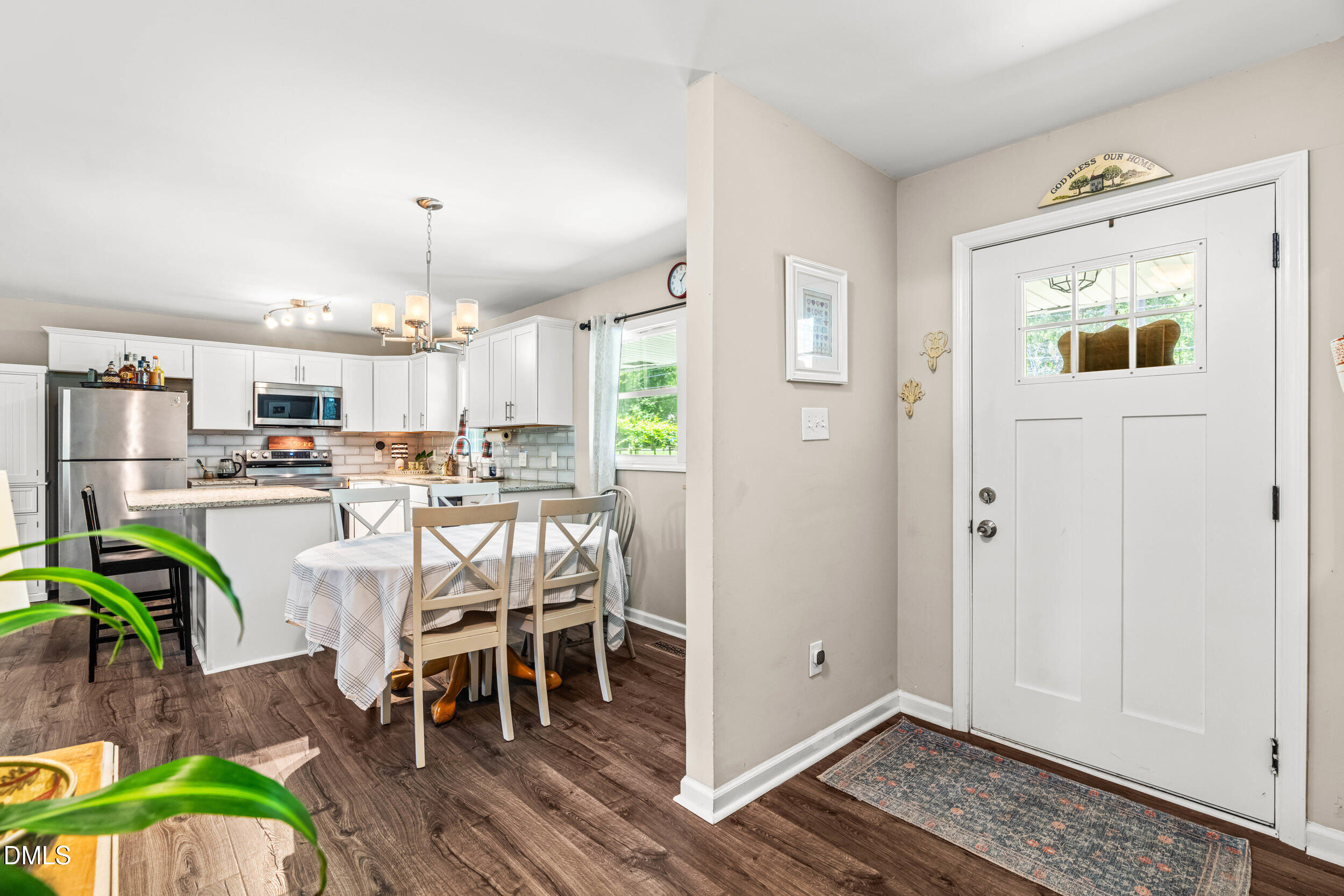 3724 Randell Road Garner, NC 27529 - Photo 20 of 32 a view of kitchen with stainless steel appliances refrigerator stove dining table and chairs
