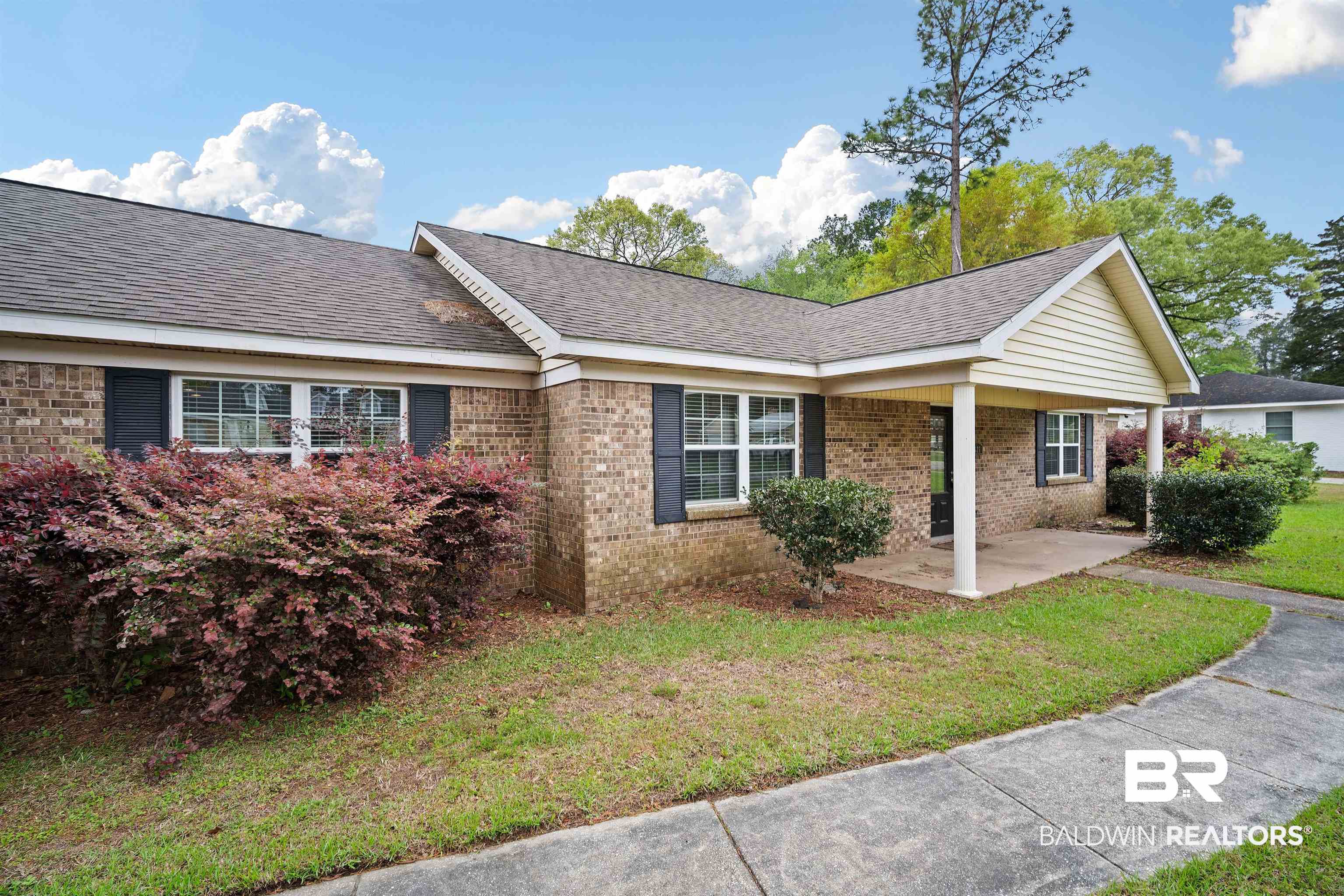 627 Spanish Main Spanish Fort, AL 36527 - Photo 4 of 39 View of front facade with a shingled roof, a front yard, and brick siding