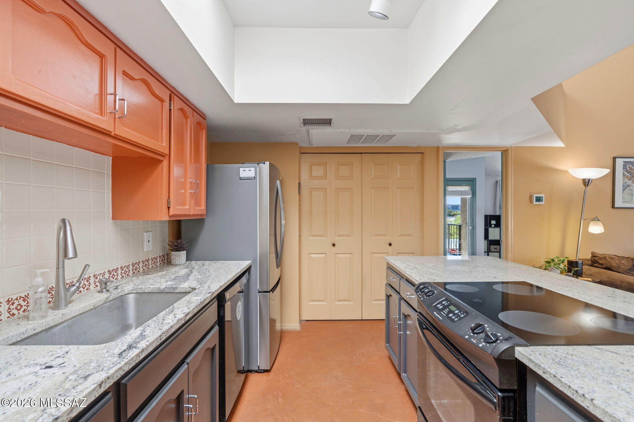 1200 East River Road, Unit G87 Tucson, AZ 85718 - Photo 12 of 30 a kitchen with a sink stove and cabinets