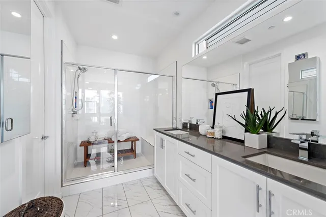 a bedroom with a bed and a flat tv screen on the dresser