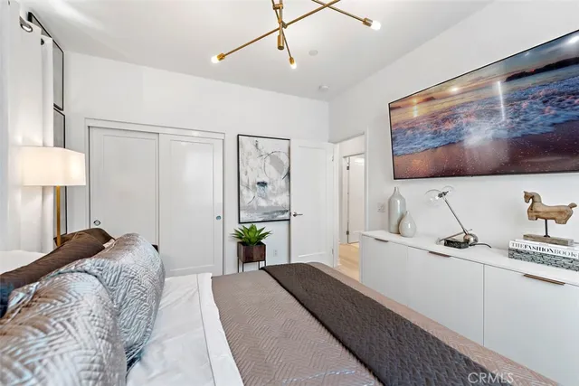 a bedroom with a bed couch and a window