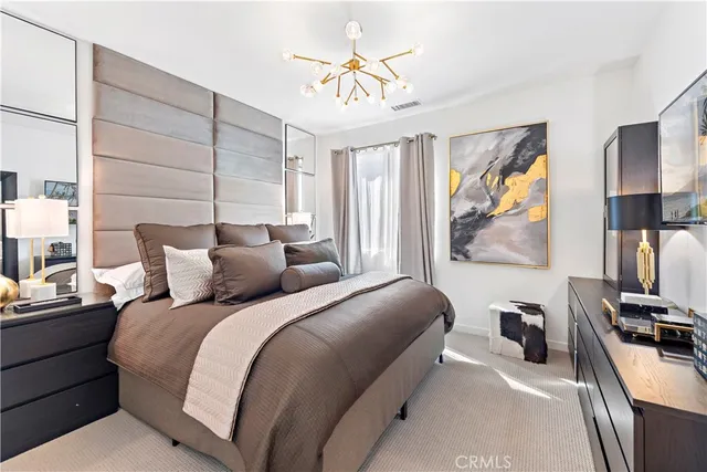 a bedroom with a bed and a mirror