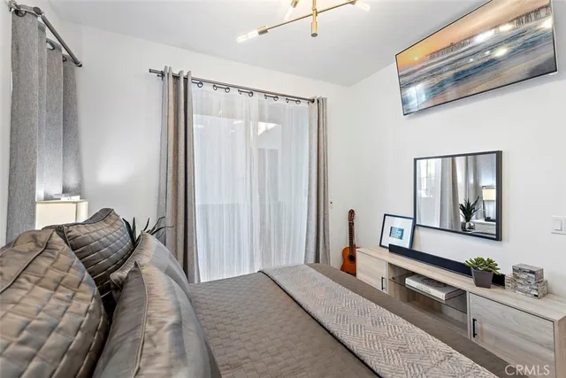 a bedroom with a bed and a chandelier