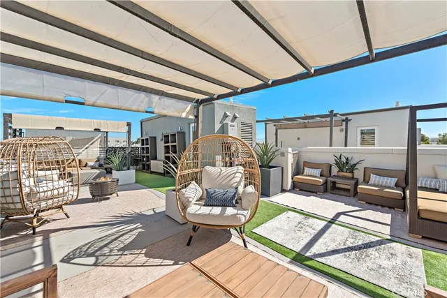 a view of a patio with couches table and chairs with potted plants