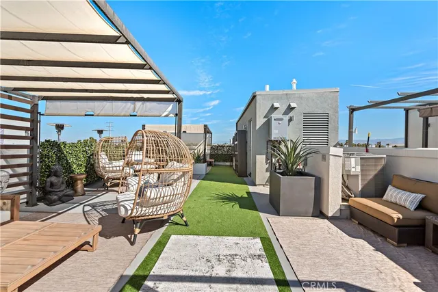 a view of a patio with chairs and plants