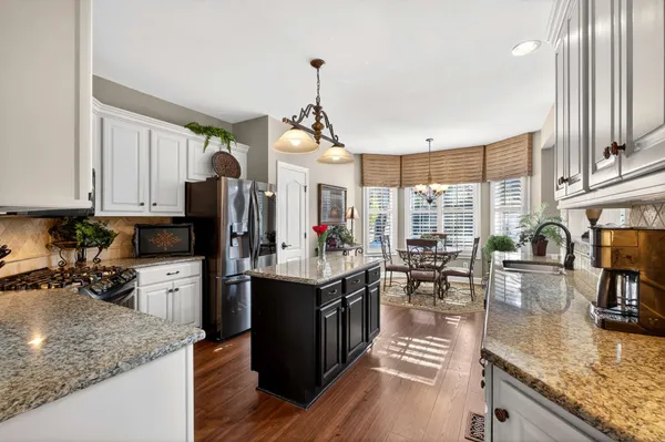 a kitchen with sink refrigerator and cabinets