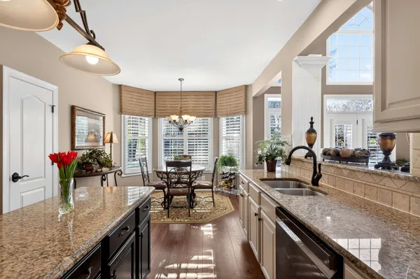 a kitchen with sink stove and cabinets