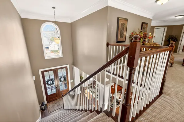 a view of entryway and hall with wooden floor