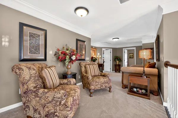 a living room with furniture and a chandelier