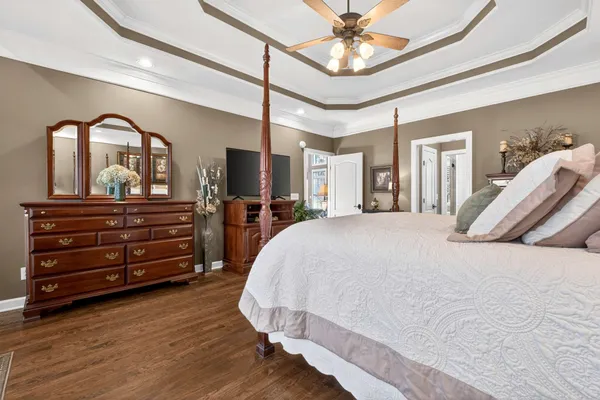 a spacious bedroom with a bed and a dresser