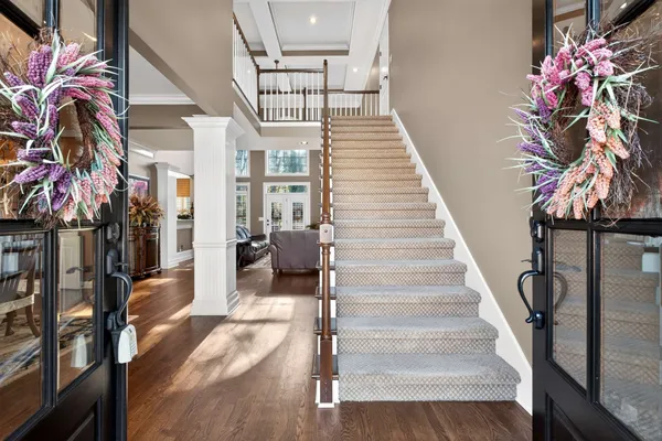 a view of entryway and hall with wooden floor