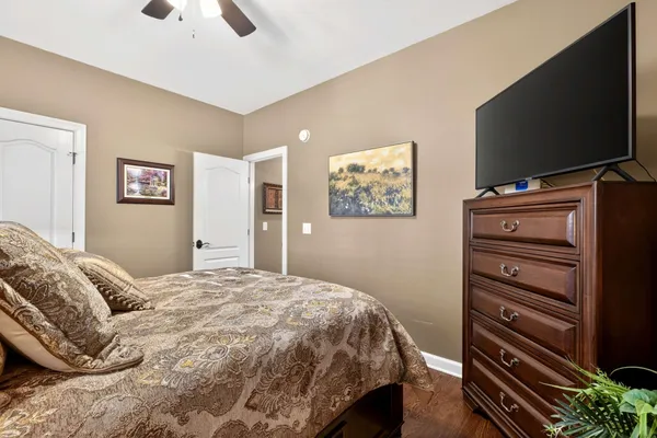 a bedroom with a bed and a flat screen tv