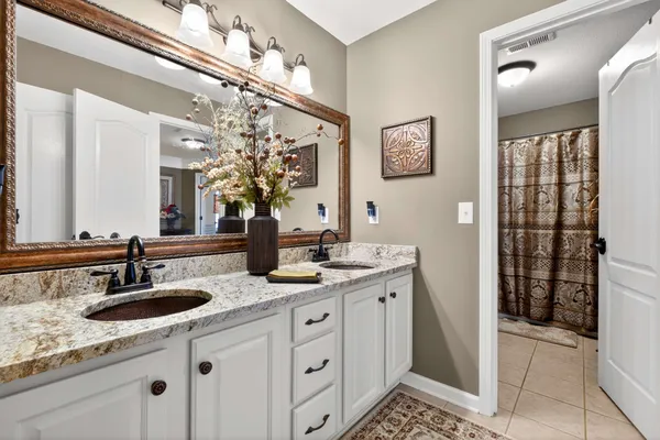 a bathroom with double sink and a mirror