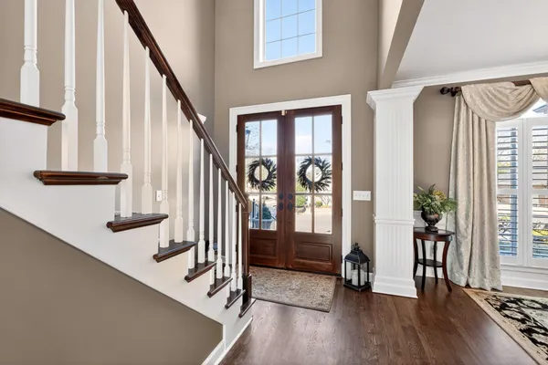 a view of an entryway with wooden floor and door