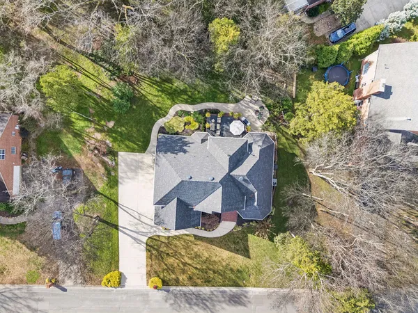 an aerial view of a house with a yard and garden