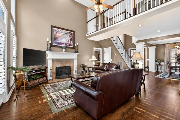 a living room with furniture a flat screen tv and a fireplace