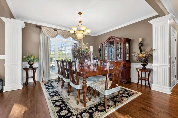 a view of a dining room with furniture window and wooden floor