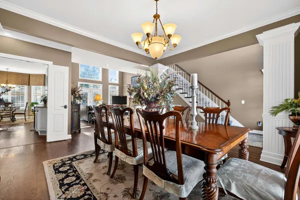a view of a dining room with furniture wooden floor and chandelier