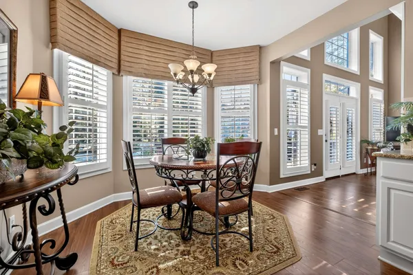 a view of a dining room with furniture window and wooden floor