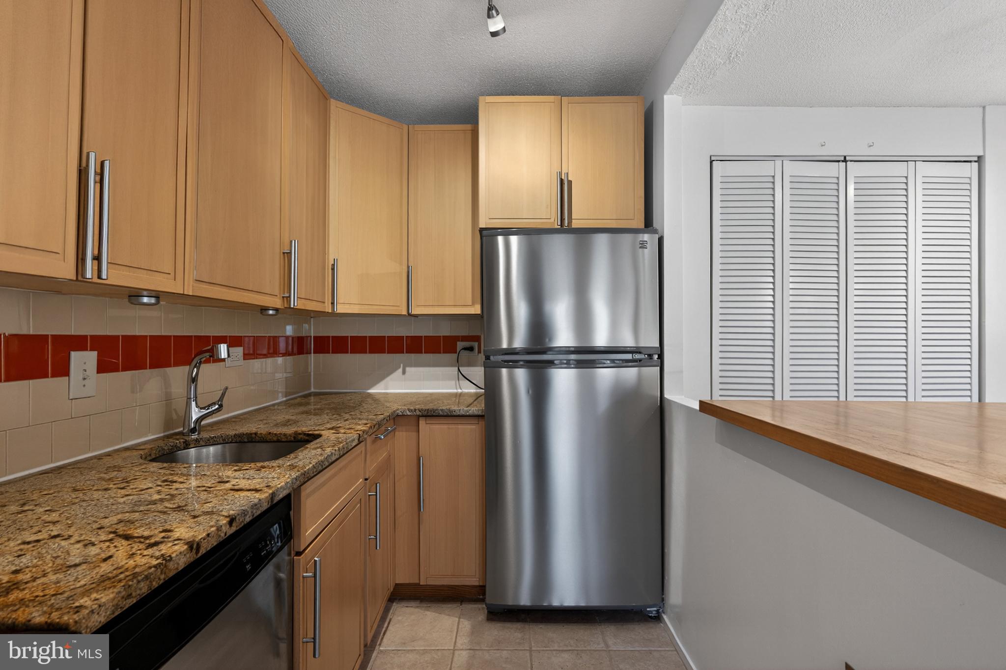 1311 Delaware Avenue Southwest Washington, DC 20024 - Photo 17 of 64 a kitchen with stainless steel appliances granite countertop a refrigerator a sink and a stove