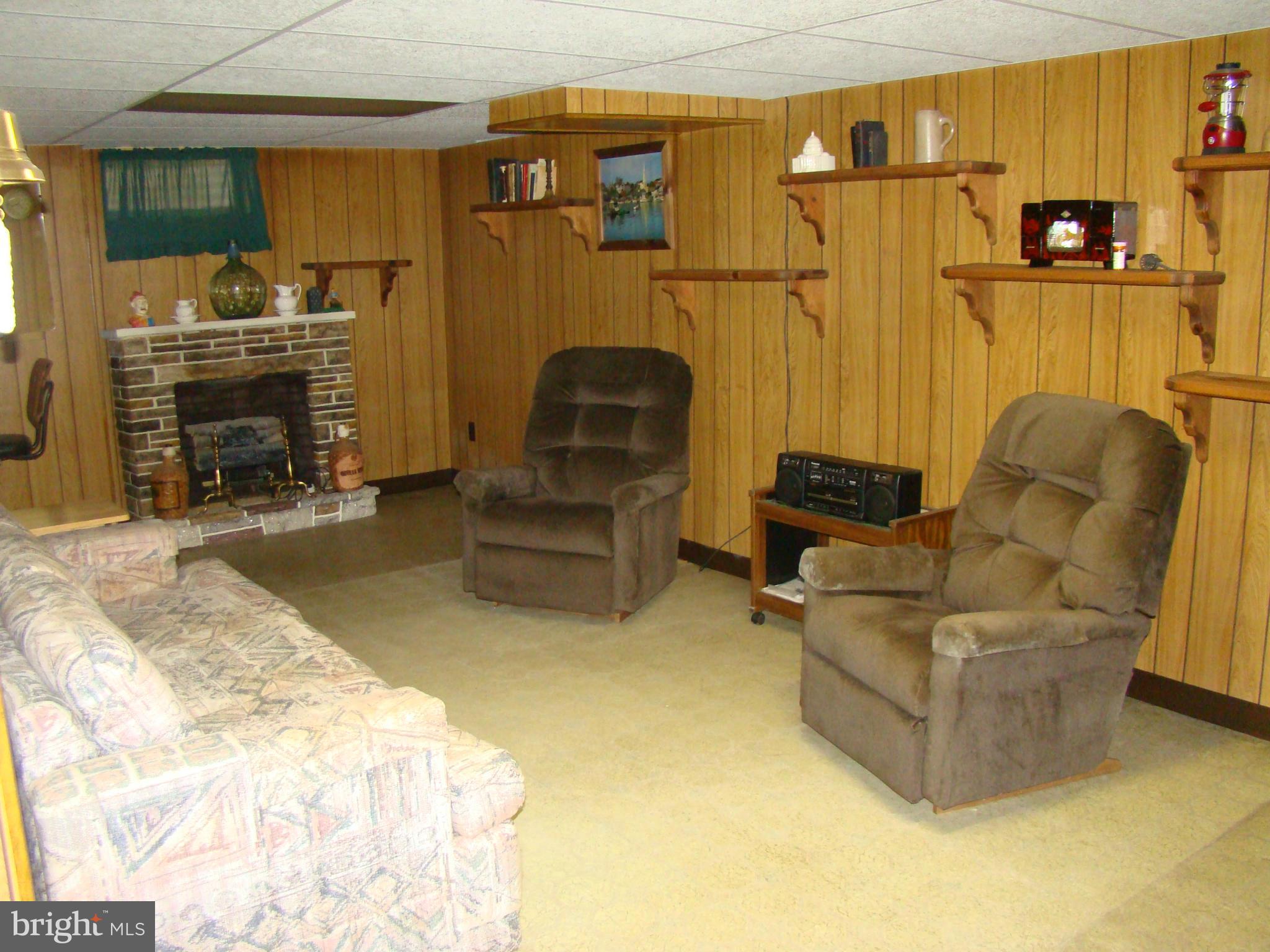 5509 Park Road Baltimore, MD 21225 - Photo 19 of 29 a living room with furniture a flat screen tv and a fireplace