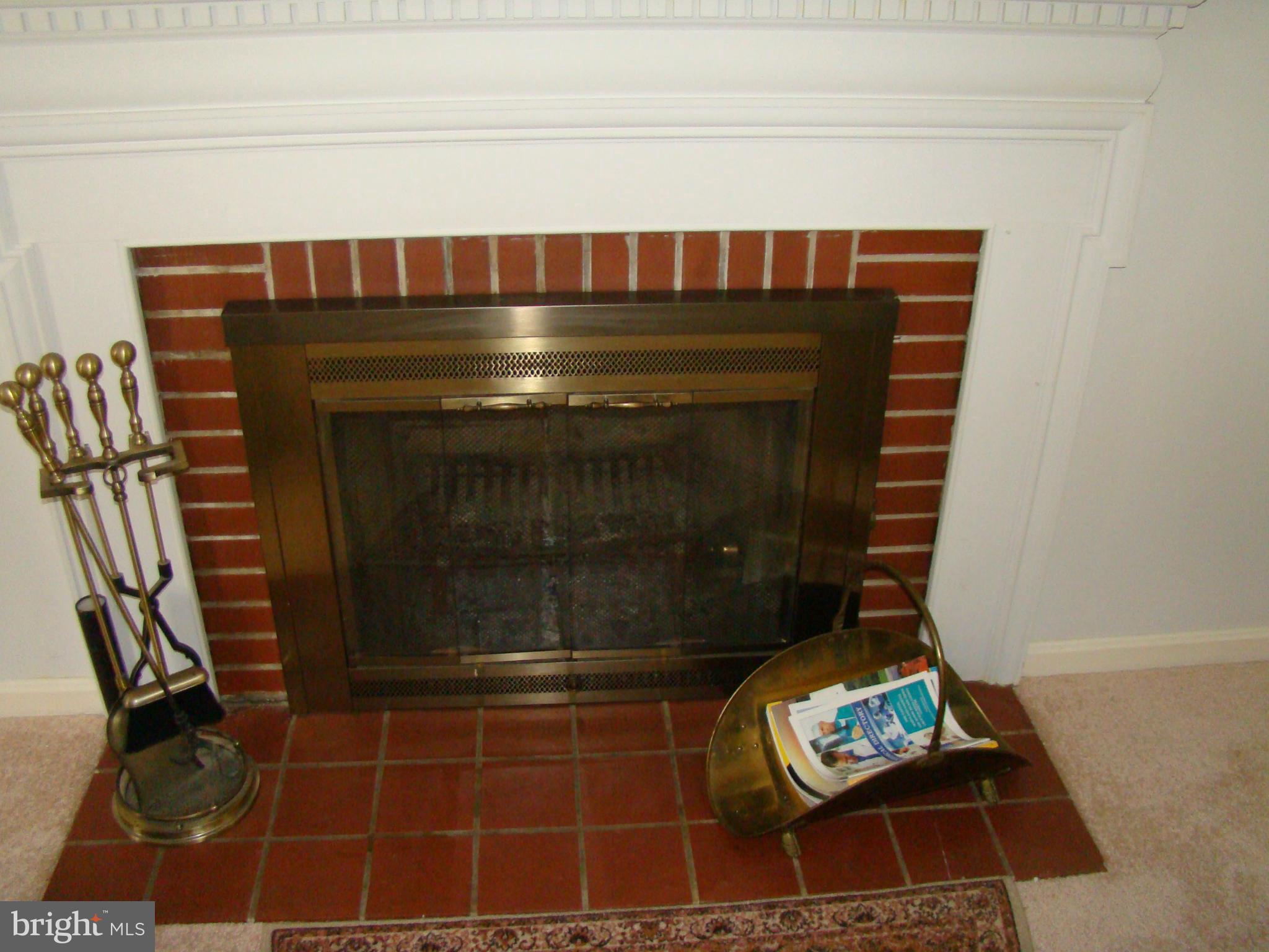 5509 Park Road Baltimore, MD 21225 - Photo 10 of 29 a fireplace sitting on top of a wooden floor