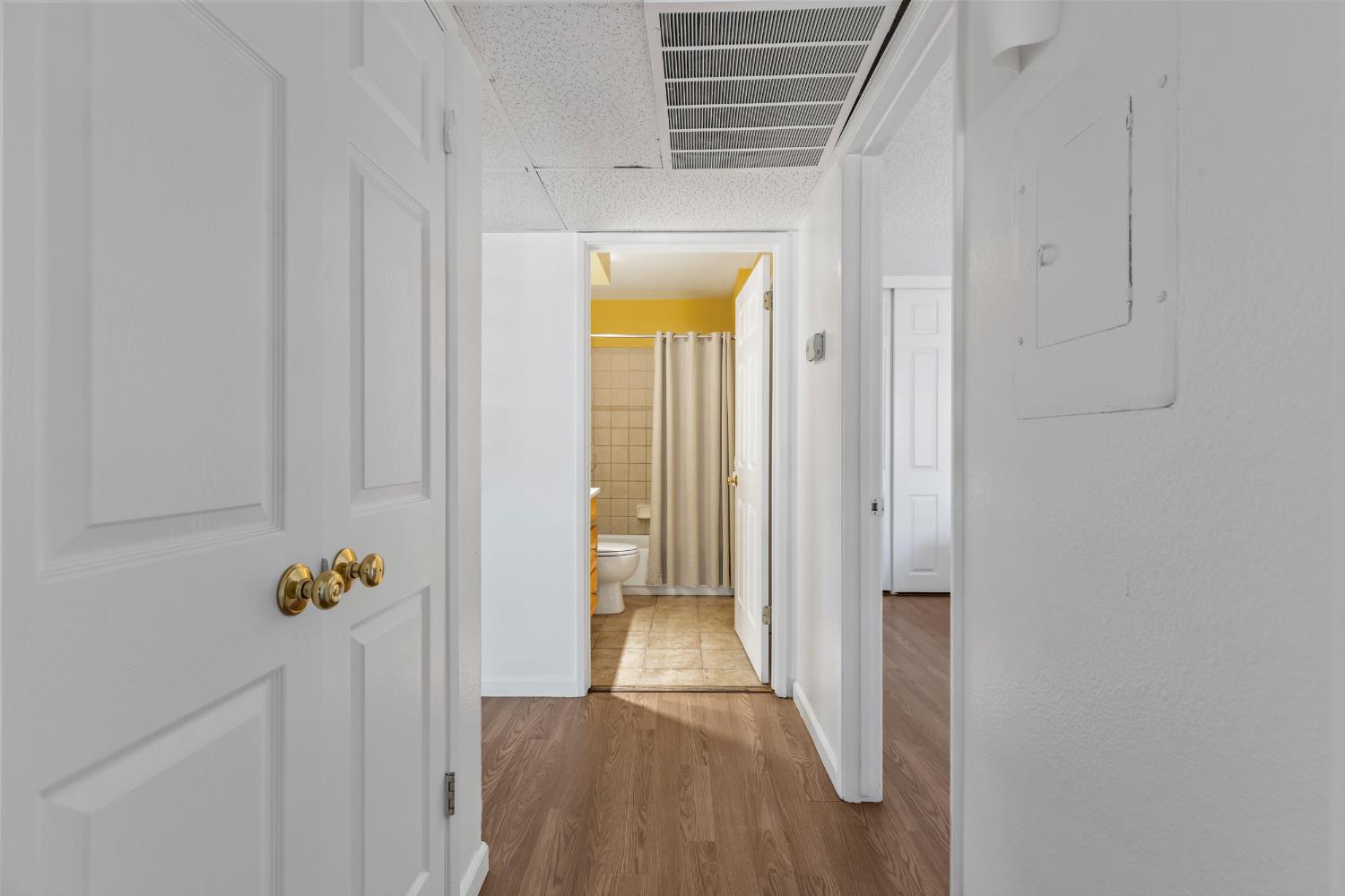 1313 Floyd Avenue, Unit 179 Modesto, CA 95355 - Photo 15 of 28 a view of a hallway with wooden floor and a livingroom