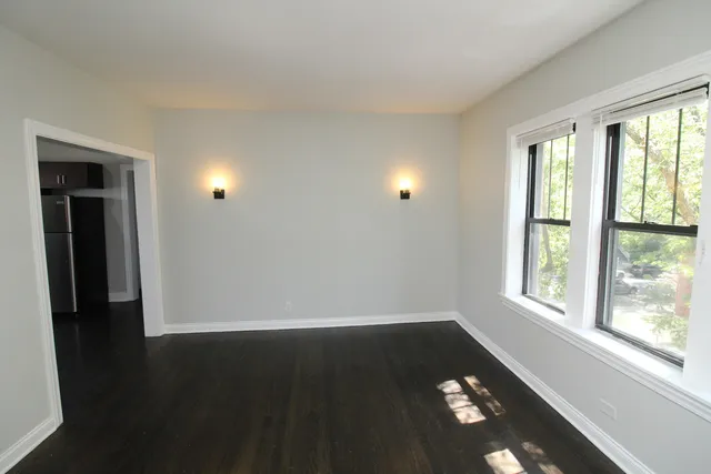 a view of an empty room with glass door