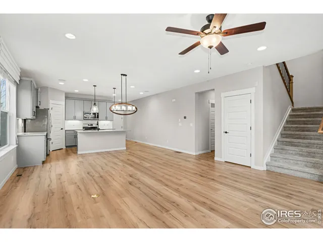 a view of kitchen with refrigerator microwave and wooden floor