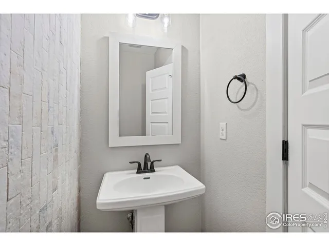 a bathroom with a sink a mirror and shower