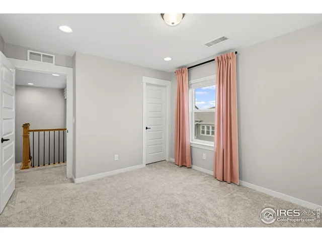 a big room with closet and wooden floor