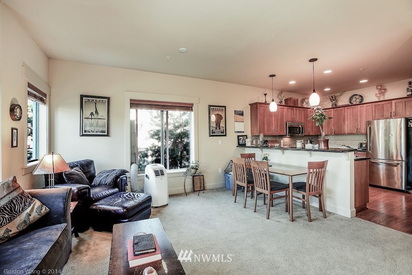 2115 201st Place Southeast, Unit F1 Bothell, WA 98012 - Photo 3 of 10 a living room with furniture and kitchen view