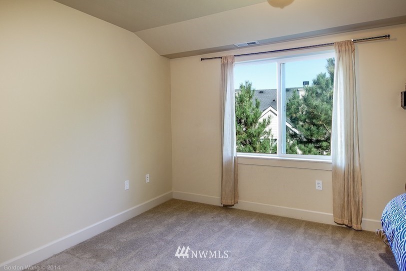 2115 201st Place Southeast, Unit F1 Bothell, WA 98012 - Photo 5 of 10 a view of an empty room with a window and wooden floor