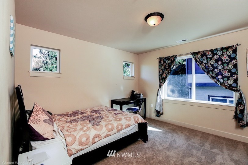 2115 201st Place Southeast, Unit F1 Bothell, WA 98012 - Photo 6 of 10 a bedroom with a bed and a window