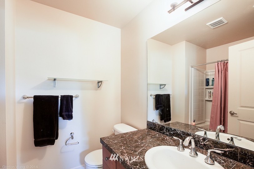 2115 201st Place Southeast, Unit F1 Bothell, WA 98012 - Photo 8 of 10 a bathroom with a sink and a mirror