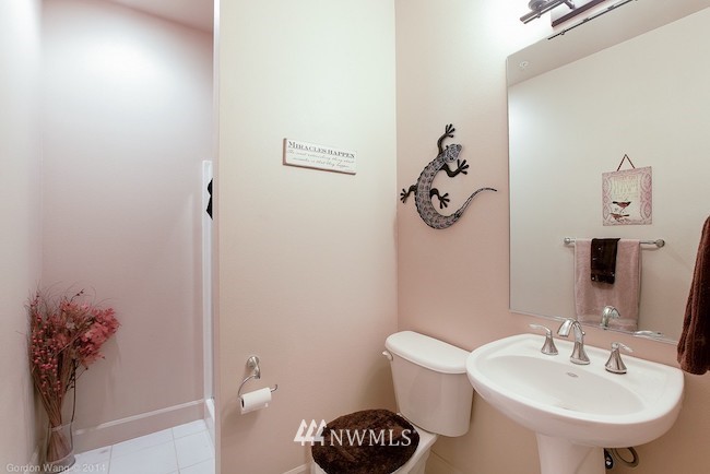 2115 201st Place Southeast, Unit F1 Bothell, WA 98012 - Photo 10 of 10 a bathroom with a toilet a sink and mirror