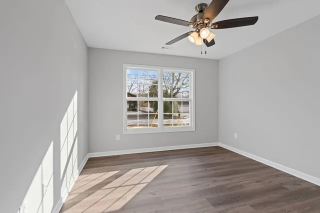 wooden floor in an empty room with a window
