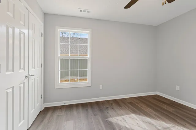 wooden floor in an empty room with a window
